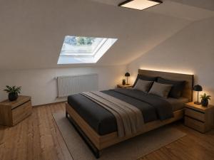 a bedroom with a large bed with a skylight at Im Weidig in Obernburg am Main