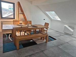 a dining room with a wooden table and chairs at Im Weidig in Obernburg am Main