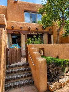 a house with stairs leading to the front door at Las Brisas de Santa fe in Santa Fe