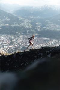 a man running on the top of a mountain at Kaiser Max Design Appartements in Innsbruck