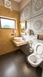 a bathroom with a toilet and a sink at Summer Stays Boho in Bhīm Tāl +21 photos