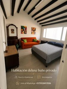 a bedroom with a bed and a couch at Hostel Casa Unicentro in Bogotá +2 photos