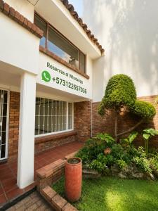 a building with a sign that reads reserves at wilderness at Hostel Casa Unicentro in Bogotá