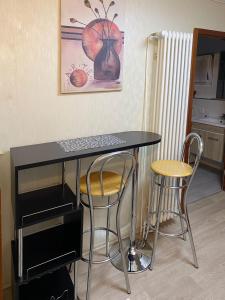 a desk with two chairs and a keyboard on it at Charlottenhöhe Apartment in Rottweil