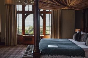 a bedroom with a canopy bed and a piano at Murrayshall Country Estate in Perth