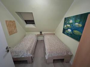 a room with two beds and a painting on the wall at Apartment Grieshop in Dinklage