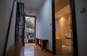 a hallway with a door leading to a bathroom with a window at Posada de Labaien in Beinza-Labayen