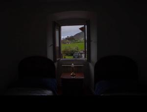 a room with a window with a view of a field at Posada de Labaien in Beinza-Labayen