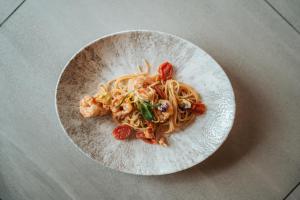 a plate of pasta and shrimp on a table at Hotel Tofana in San Cassiano