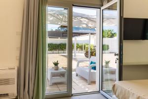 a bedroom with sliding glass doors to a patio at Affittacamere Mare Poetto Cagliari in Quartu Sant'Elena