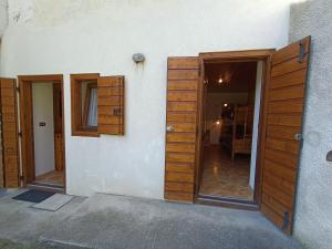 a room with two wooden cabinets and a door at Coldemies apartment in Alleghe