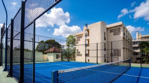 a tennis court in front of a building at Lancaster Accra in Accra