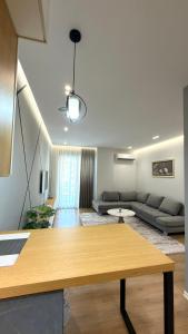 a living room with a table and a couch at George apartments2023 in Korçë