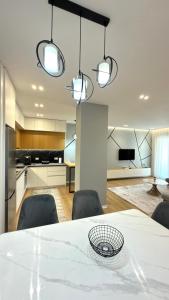 a dining room with a white table and chairs at George apartments2023 in Korçë