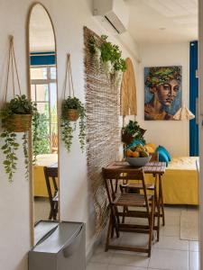 a kitchen with a table with a bowl of fruit on it at STUDIO PIEDS DANS L EAU A SCHOELCHER in Schœlcher