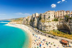a view of a beach with umbrellas and people at Salyn Apartments - The Heart of Tropea - Your Perfect Stay in Tropea