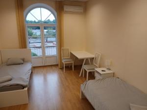 a room with a bed and a table and a window at Venta stay in Ventspils