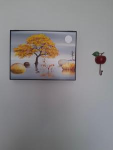 a framed picture of a tree in the water at Heavenly joy in Patra