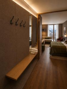 a hotel room with a bed and a living room at Hotel Steffisalp - Ski-in & Ski-out am Arlberg in Warth am Arlberg +57 photos