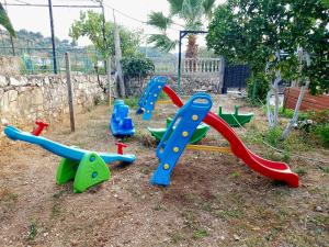 a group of playground equipment in a yard at Denaj House in Himare