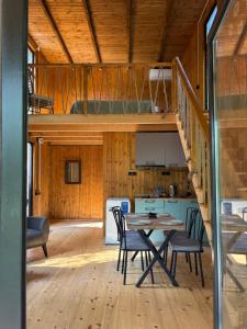 a dining room and kitchen with a table and chairs at Babitouli-1 in Niabauri +43 photos