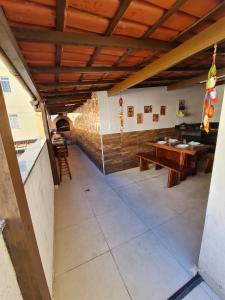a restaurant with wooden ceilings and tables in a room at Apartamento 3 Quartos, Churrasqueira, Vista Mar, Varanda, 5 min da praia in Guarapari