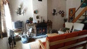 a living room with a couch and a fireplace at La Caseta del Port in Alfara de Carles