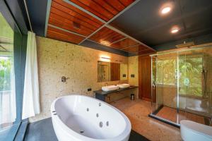 a large bathroom with a tub and a shower at Open Hotel by Olive - Biranji Aqua Reatreat in Chikmagalūr +46 photos