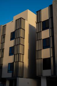 a tall building with a blue sky behind it at برايم سيغنتشر in Al Khobar +7 photos