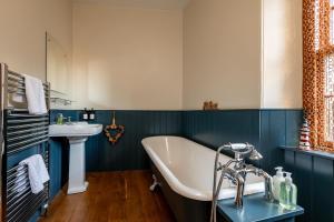 a bathroom with a bath tub and a sink at Corner House - Elie & Earlsferry in Elie +23 photos