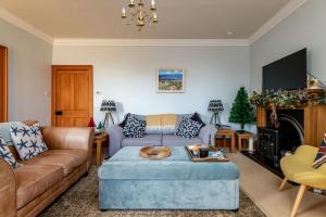 a living room with a couch and a table at Corner House - Elie & Earlsferry in Elie