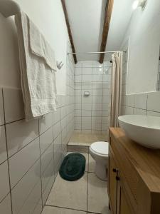 a bathroom with a toilet and a sink at Anido House in Ollantaytambo +36 photos