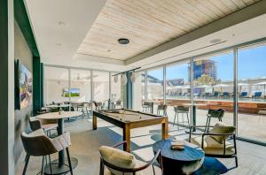 a restaurant with tables and chairs and windows at CozySuites at Adeline in Phoenix