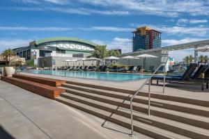 a swimming pool with stairs and a building at CozySuites at Adeline in Phoenix