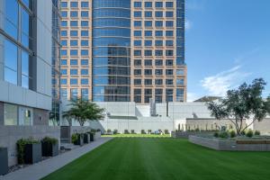 a rendering of a lawn in front of a building at CozySuites at Adeline in Phoenix