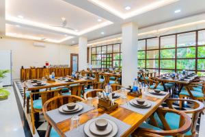 a restaurant with wooden tables and chairs at Manas Resort Udaipur in Udaipur