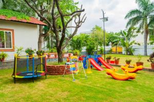 a playground in a yard with colorful slides at Manas Resort Udaipur in Udaipur