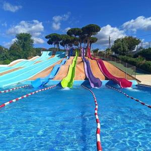 a swimming pool with a colorful water slide at Pool and sea 20' from Barcelona in Premiá de Mar