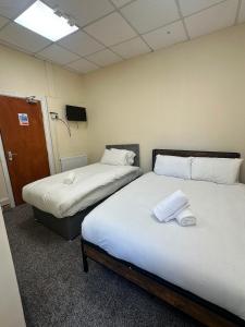 a room with two beds in a room at Victoria Hotel Blackpool in Blackpool