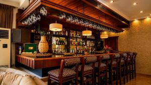 a bar with a bunch of chairs sitting at it at ANADOL Hotel & Pool Central Kyrenia in Temblos