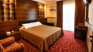 a hotel room with a bed and a couch at ANADOL Hotel & Pool Central Kyrenia in Temblos