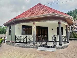 a small white house with a red roof at El Gado Casas in Kampala