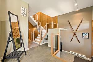 a room with stairs and a large clock on the wall at Tremblant Prestige - Clairiere 406 in Mont-Tremblant