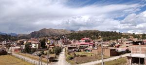 a small town in the mountains with houses and buildings at Hospedaje Rumichaca in Cusco