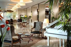 a white piano in a lobby with chairs and a table at Sonesta Hotel Tower & Casino Cairo in Cairo