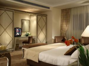 a hotel room with a bed and a desk at Sonesta Hotel Tower & Casino Cairo in Cairo