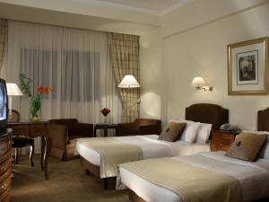 a hotel room with two beds and a television at Sonesta Hotel Tower & Casino Cairo in Cairo