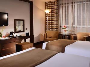 a hotel room with two beds and a table at Sonesta Hotel Tower & Casino Cairo in Cairo +194 photos