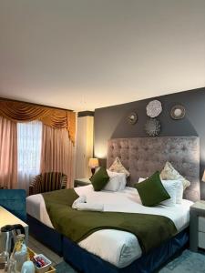 a bedroom with a large bed with green and white pillows at Marion Lodge in Johannesburg +218 photos