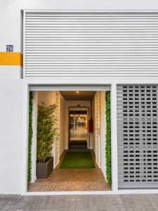 a building with an open door with plants in it at Musa in Valencia